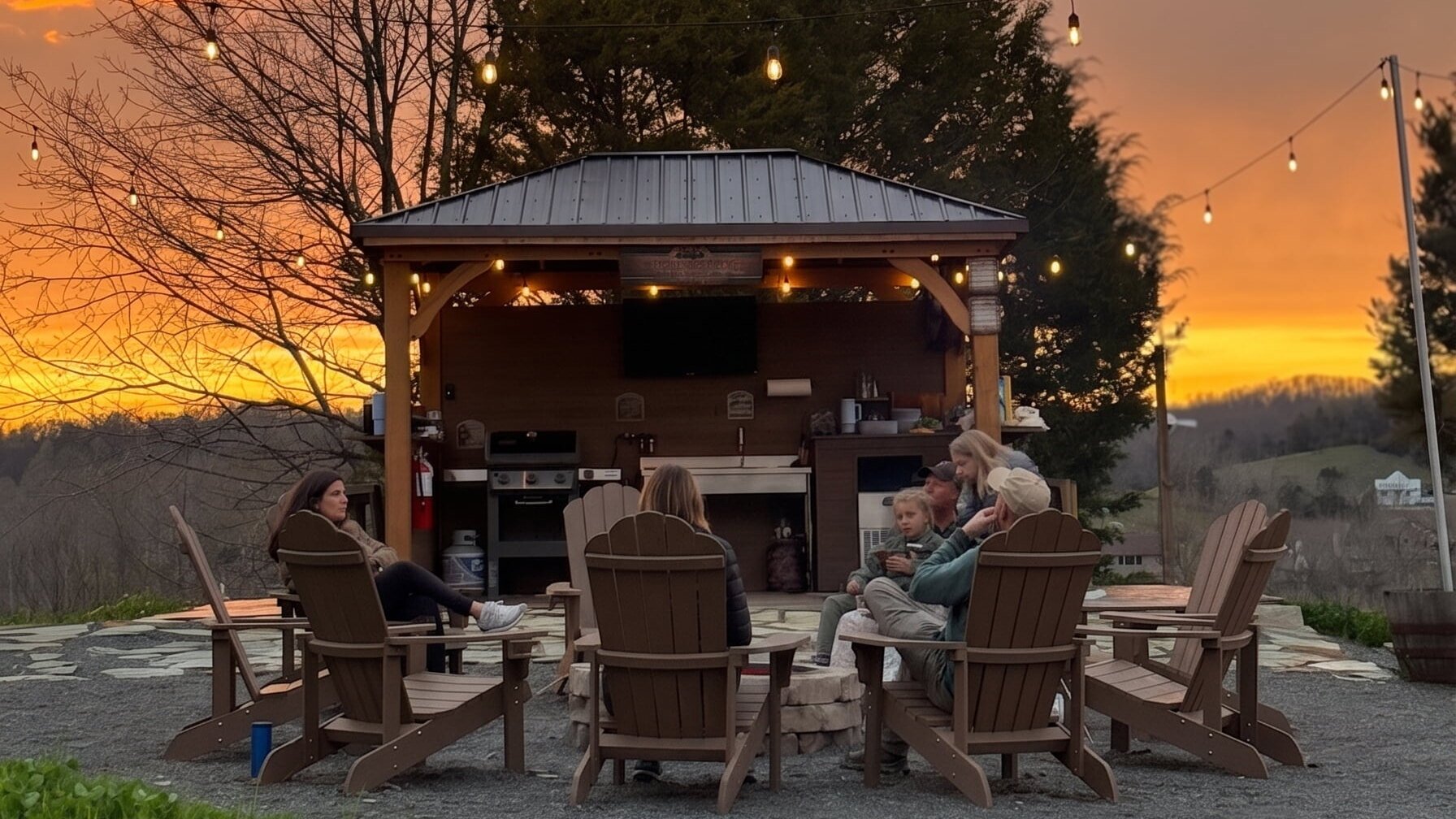 Outdoor Kitchen Sunset Sky The outdoor community kitchen and firepit under a sunset sky